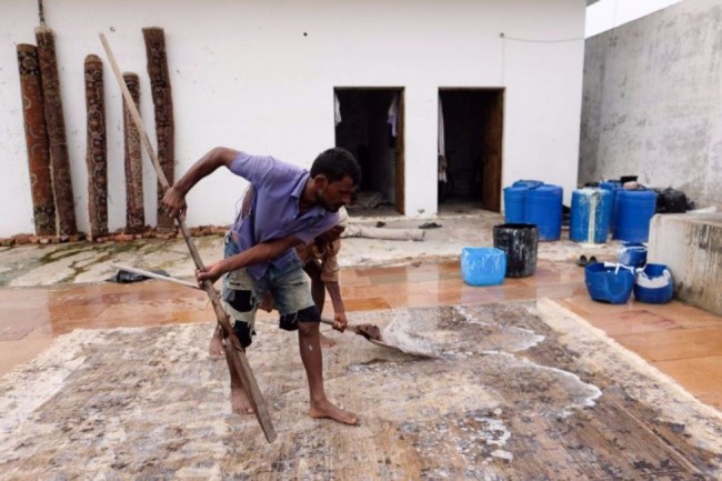man washing rug