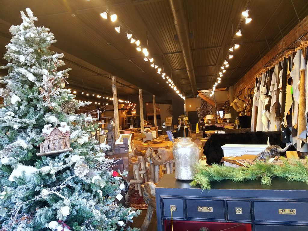 Green Front Furniture with holiday selections, including decorated trees, garlands, and lights